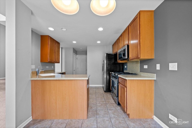 114 Devoe Dr N, Oswego, IL 60543 - kitchen with appliances with stainless steel finishes, light countertops, recessed lighting, light tile patterned floors, and a peninsula