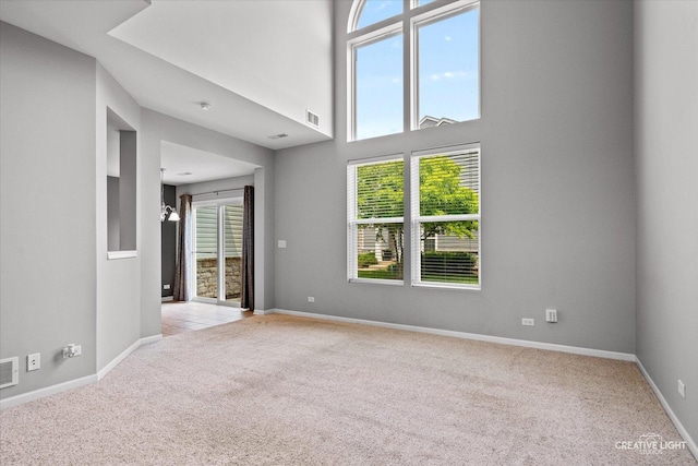114 Devoe Dr N, Oswego, IL 60543 - carpeted empty room with healthy amount of natural light and a high ceiling
