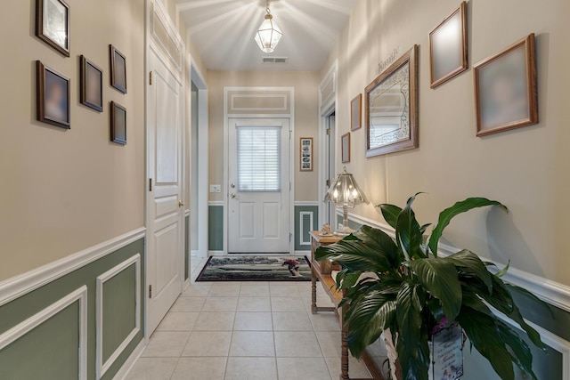 11692 Sunderlin Dr, Huntley, IL 60142 - doorway featuring a wainscoted wall, a decorative wall, and light tile patterned floors