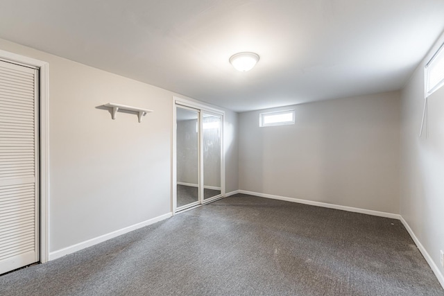 102 Mattek Ave, Dekalb, IL 60115 - unfurnished bedroom with baseboards and dark colored carpet