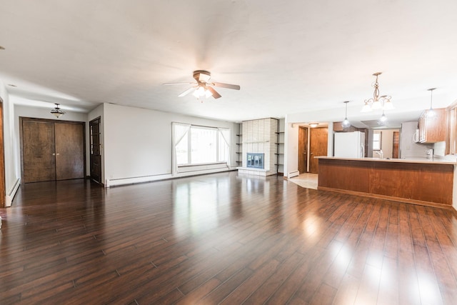 102 Mattek Ave, Dekalb, IL 60115 - unfurnished living room with a ceiling fan, dark wood-type flooring, and a baseboard heating unit