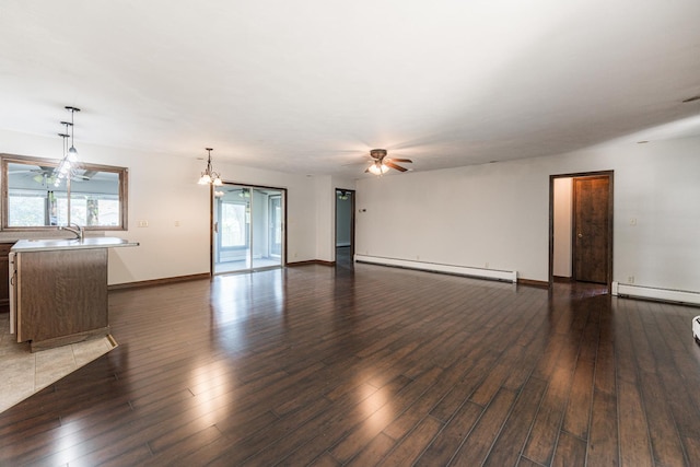 102 Mattek Ave, Dekalb, IL 60115 - unfurnished living room with a baseboard heating unit, wood finished floors, and ceiling fan