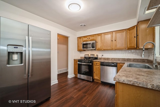 135 Flora Ave, Glenview, IL 60025 - kitchen featuring appliances with stainless steel finishes, dark wood-type flooring, backsplash, and brown cabinetry