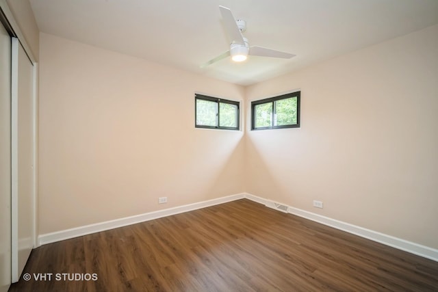 135 Flora Ave, Glenview, IL 60025 - unfurnished bedroom with dark wood-style floors, a closet, and a ceiling fan