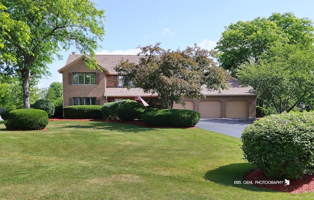 3710 Spy Glass Ridge Rd, Crystal Lake, IL 60012 - view of front of property with a garage, driveway, a front yard, a chimney, and brick siding