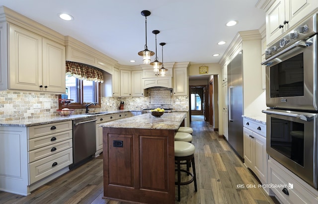3710 Spy Glass Ridge Rd, Crystal Lake, IL 60012 - kitchen featuring stainless steel appliances, a kitchen island, dark wood-style floors, backsplash, and cream cabinetry