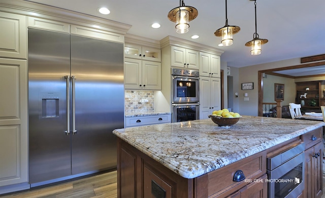 3710 Spy Glass Ridge Rd, Crystal Lake, IL 60012 - kitchen with built in appliances, light stone counters, pendant lighting, light wood-style floors, and backsplash