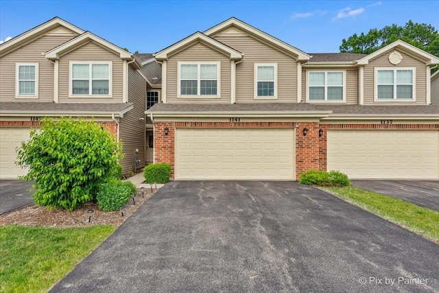 1141 Westlake Dr, Cary, IL 60013 - multi unit property featuring brick siding, an attached garage, and asphalt driveway