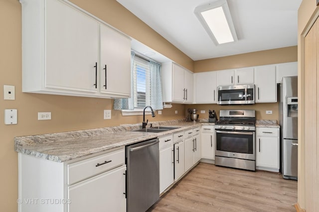 2477 Smithfield Ct, Aurora, IL 60503 - kitchen with stainless steel appliances, white cabinets, and light wood-type flooring