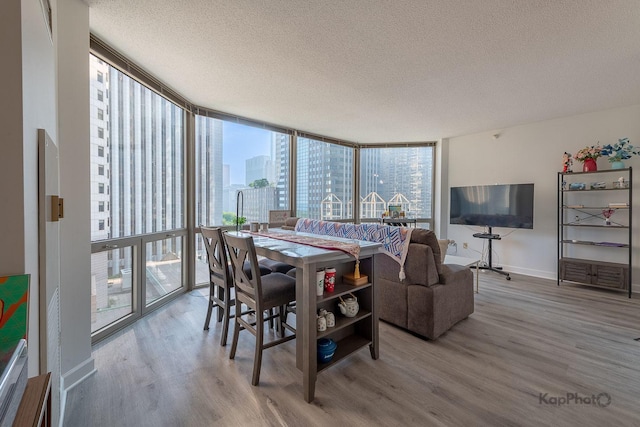 222 N Columbus Dr Unit 912, Chicago, IL 60601 - dining area with a textured ceiling, wood finished floors, and a wall of windows