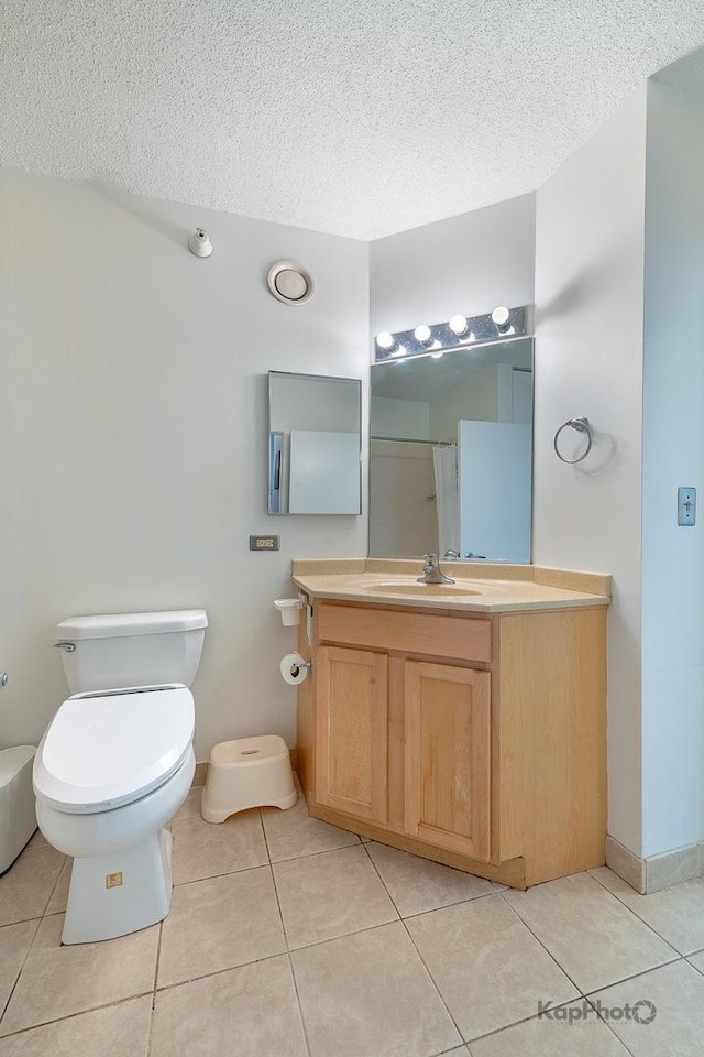 222 N Columbus Dr Unit 912, Chicago, IL 60601 - bathroom featuring vanity, tile patterned flooring, a textured ceiling, and a shower with curtain