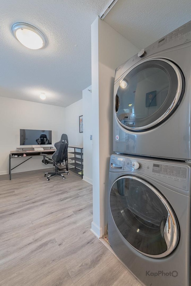 222 N Columbus Dr Unit 912, Chicago, IL 60601 - laundry area featuring stacked washer / dryer, a textured ceiling, and wood finished floors