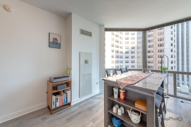 222 N Columbus Dr Unit 912, Chicago, IL 60601 - dining space with a textured ceiling, expansive windows, and light wood-type flooring