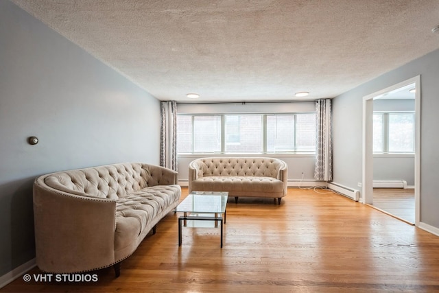 200 Ridge Ave Unit 2C, Evanston, IL 60202 - living room featuring a textured ceiling, wood finished floors, and baseboard heating