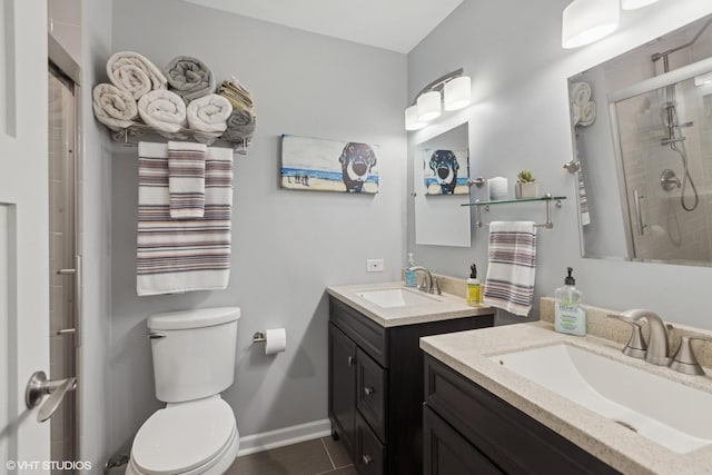 bathroom with two vanities, a stall shower, and tile patterned flooring