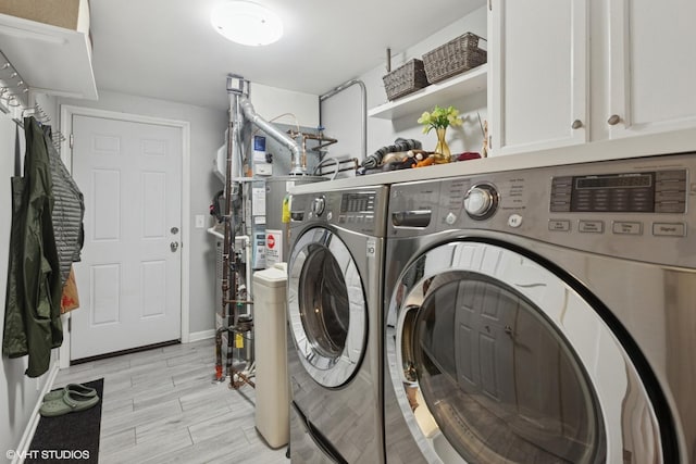 washroom with separate washer and dryer and cabinet space