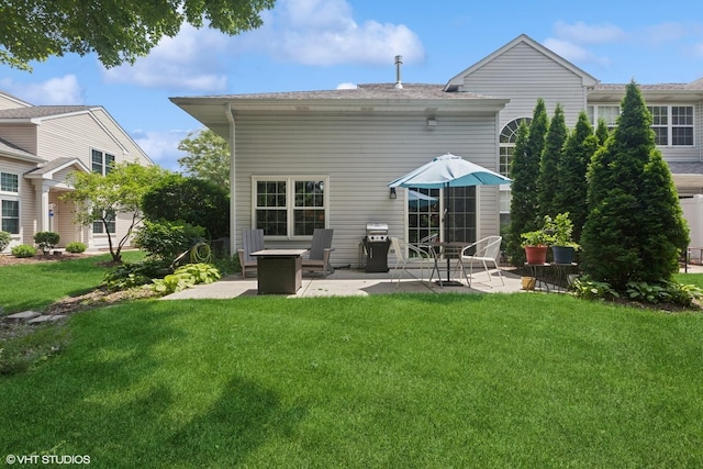 rear view of property featuring a patio area and a lawn