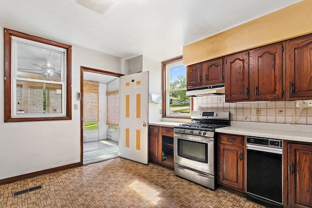 300 Stone St, South Elgin, IL 60177 - kitchen with stainless steel gas range, under cabinet range hood, healthy amount of natural light, and light countertops