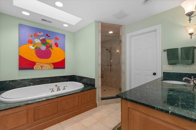 1005 Hiawatha Ln, Riverwoods, IL 60015 - full bathroom featuring vanity, a skylight, a shower stall, a garden tub, and tile patterned flooring
