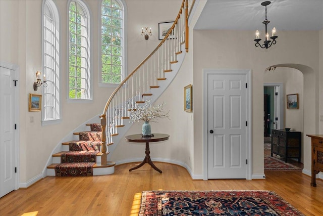 1005 Hiawatha Ln, Riverwoods, IL 60015 - entryway featuring arched walkways, wood finished floors, stairs, and a high ceiling