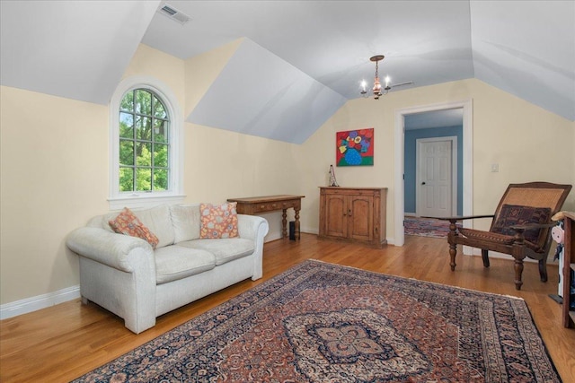 1005 Hiawatha Ln, Riverwoods, IL 60015 - living area with lofted ceiling, wood finished floors, and a chandelier