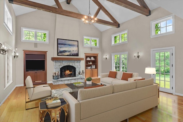 1005 Hiawatha Ln, Riverwoods, IL 60015 - living area featuring high vaulted ceiling, beam ceiling, light wood-type flooring, a stone fireplace, and a chandelier