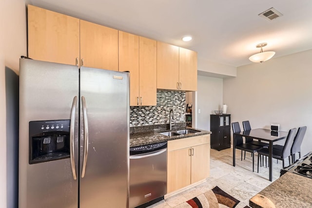 7316 N Honore St Unit 306, Chicago, IL 60626 - kitchen featuring stainless steel appliances, light brown cabinetry, tasteful backsplash, and dark stone counters