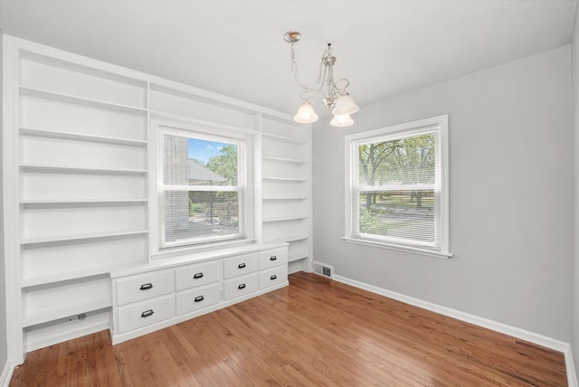 255 Irving Blvd, Chicago Heights, IL 60411 - empty room featuring a chandelier, light wood-style flooring, and built in features
