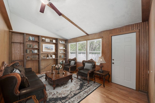 255 Irving Blvd, Chicago Heights, IL 60411 - living room with vaulted ceiling, a ceiling fan, light wood finished floors, and wood walls