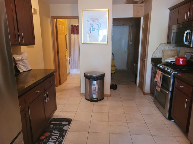 18324 Pond View Ct, Tinley Park, IL 60477 - kitchen featuring appliances with stainless steel finishes, dark countertops, light tile patterned floors, and dark brown cabinetry