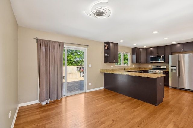 357 Sword Way, Bolingbrook, IL 60440 - kitchen with stainless steel appliances, a peninsula, dark brown cabinetry, light wood-style flooring, and open shelves
