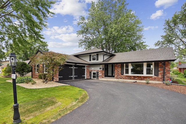 232 S Walnut St, Glenwood, IL 60425 - tri-level home with an attached garage, driveway, a front lawn, and brick siding