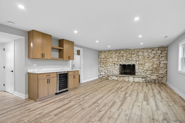232 S Walnut St, Glenwood, IL 60425 - kitchen featuring wine cooler, open shelves, light wood finished floors, recessed lighting, and a stone fireplace