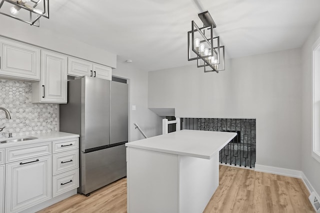 232 S Walnut St, Glenwood, IL 60425 - kitchen with freestanding refrigerator, backsplash, light wood-style floors, and white cabinets