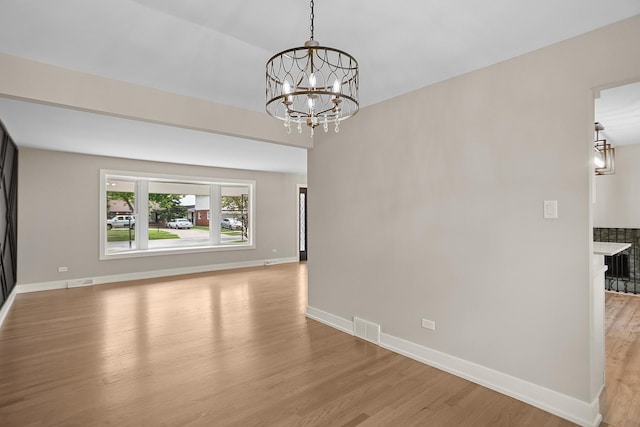 232 S Walnut St, Glenwood, IL 60425 - spare room with light wood-style floors and a chandelier