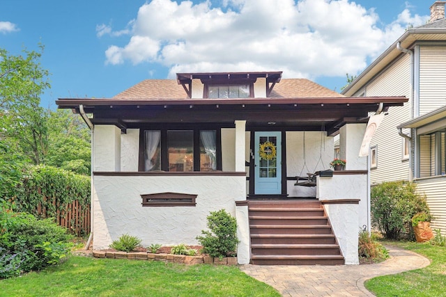 837 Wesley Ave, Oak Park, IL 60304 - view of front facade with stucco siding, a porch, and roof with shingles