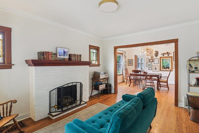 837 Wesley Ave, Oak Park, IL 60304 - living area featuring a chandelier, ornamental molding, wood finished floors, and a fireplace