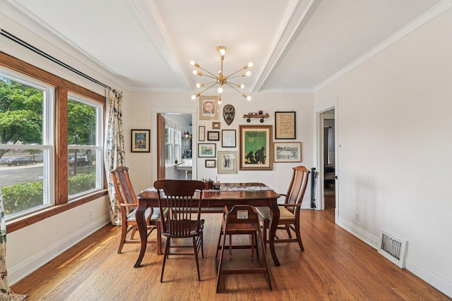 837 Wesley Ave, Oak Park, IL 60304 - dining area featuring wood finished floors, a chandelier, and crown molding