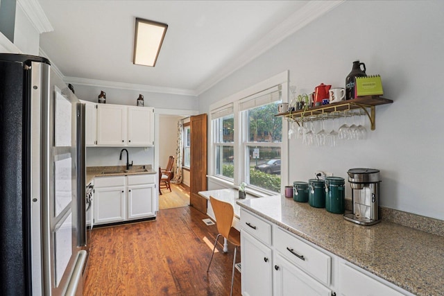 837 Wesley Ave, Oak Park, IL 60304 - kitchen with freestanding refrigerator, ornamental molding, white cabinets, dark wood-type flooring, and light stone counters