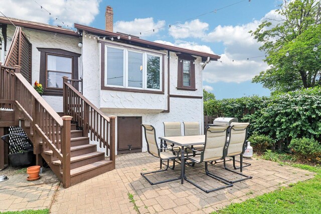 837 Wesley Ave, Oak Park, IL 60304 - back of property with stucco siding, a patio area, and outdoor dining space