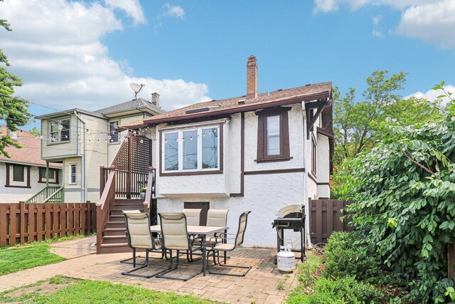 837 Wesley Ave, Oak Park, IL 60304 - rear view of property with stucco siding, a patio, stairway, and a chimney