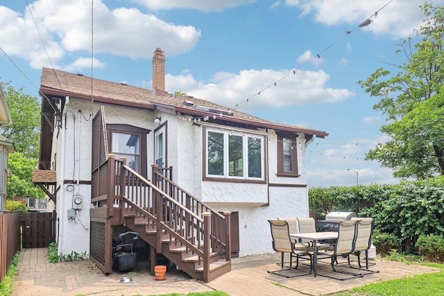 837 Wesley Ave, Oak Park, IL 60304 - back of property featuring stucco siding, a chimney, and outdoor dining area