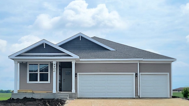 9900 Humbolt St, Huntley, IL 60142 - view of front of home with an attached garage, driveway, roof with shingles, and covered porch