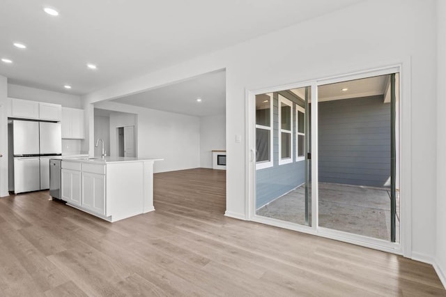 9900 Humbolt St, Huntley, IL 60142 - kitchen featuring appliances with stainless steel finishes, white cabinets, recessed lighting, light wood finished floors, and open floor plan