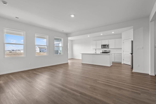 9900 Humbolt St, Huntley, IL 60142 - unfurnished living room with recessed lighting and dark wood-style floors