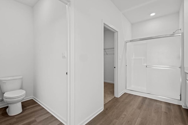 9900 Humbolt St, Huntley, IL 60142 - bathroom featuring wood finished floors, a stall shower, a spacious closet, and recessed lighting