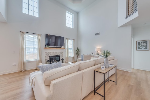 25320 W Alison Rd, Plainfield, IL 60586 - living room featuring a towering ceiling, light wood-style floors, and a fireplace