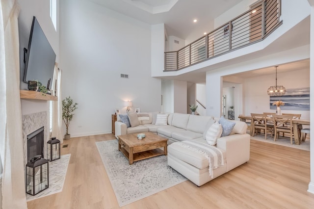 25320 W Alison Rd, Plainfield, IL 60586 - living room with a high ceiling, wood finished floors, a fireplace with flush hearth, a chandelier, and recessed lighting