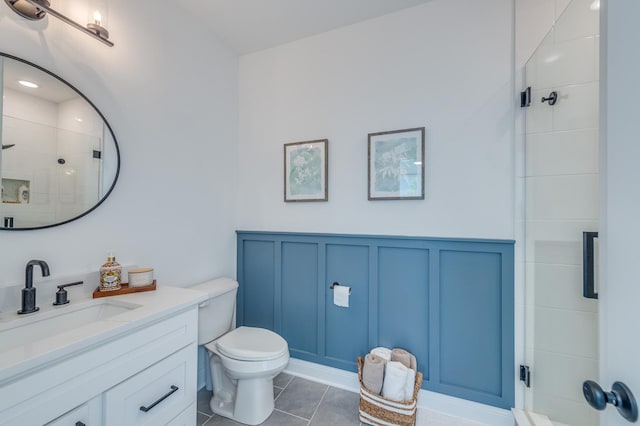 25320 W Alison Rd, Plainfield, IL 60586 - bathroom with a decorative wall, vanity, a tile shower, tile patterned floors, and wainscoting