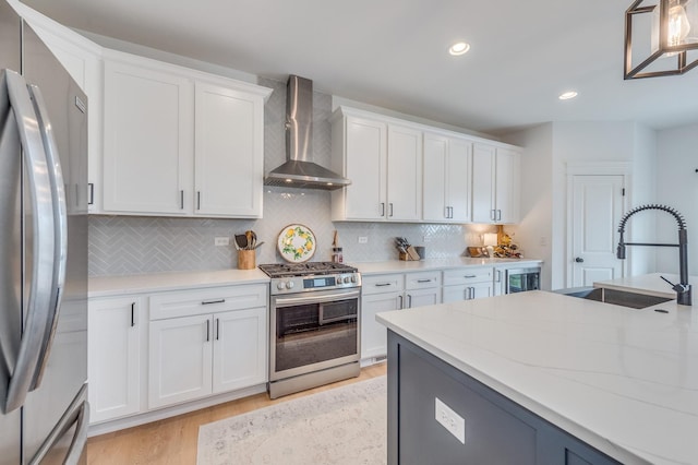 25320 W Alison Rd, Plainfield, IL 60586 - kitchen featuring wall chimney range hood, stainless steel appliances, light wood finished floors, white cabinets, and tasteful backsplash